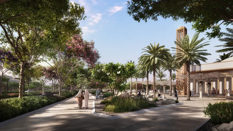 Wadeem: landscaped walkway with palms beside community buildings, developer render