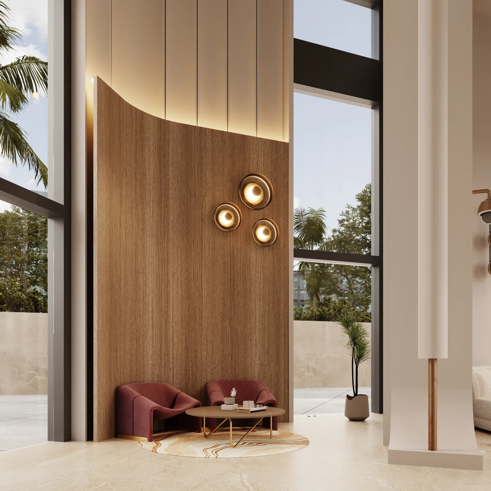 A seating corner of the lobby: a curved timber feature wall with three round brass wall lights, two burgundy armchairs and a round coffee table, palms outside the glazing