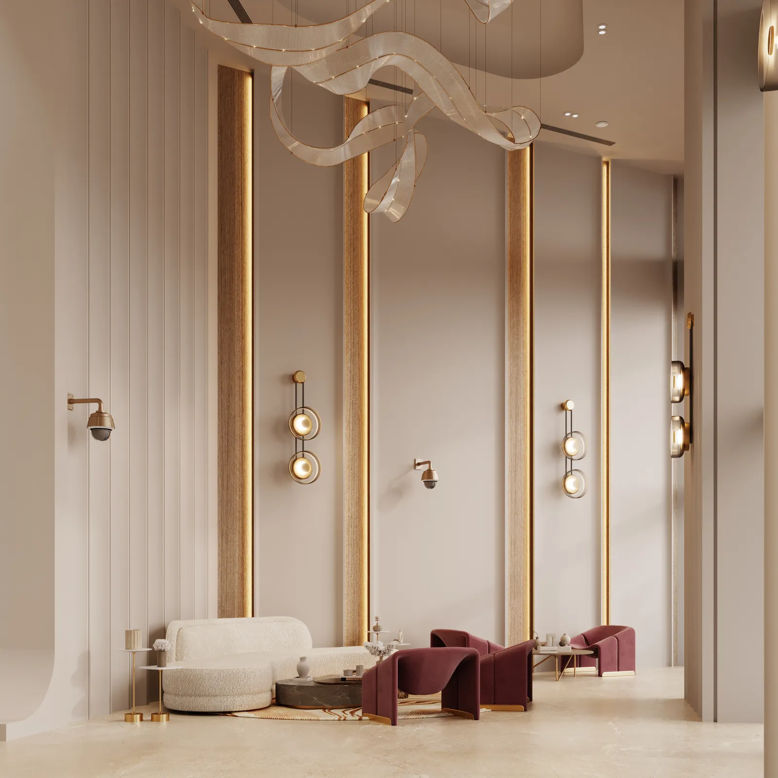 The lobby lounge: a curved cream sofa and burgundy armchairs beneath the ribbon chandelier, with brass-lined wall panels
