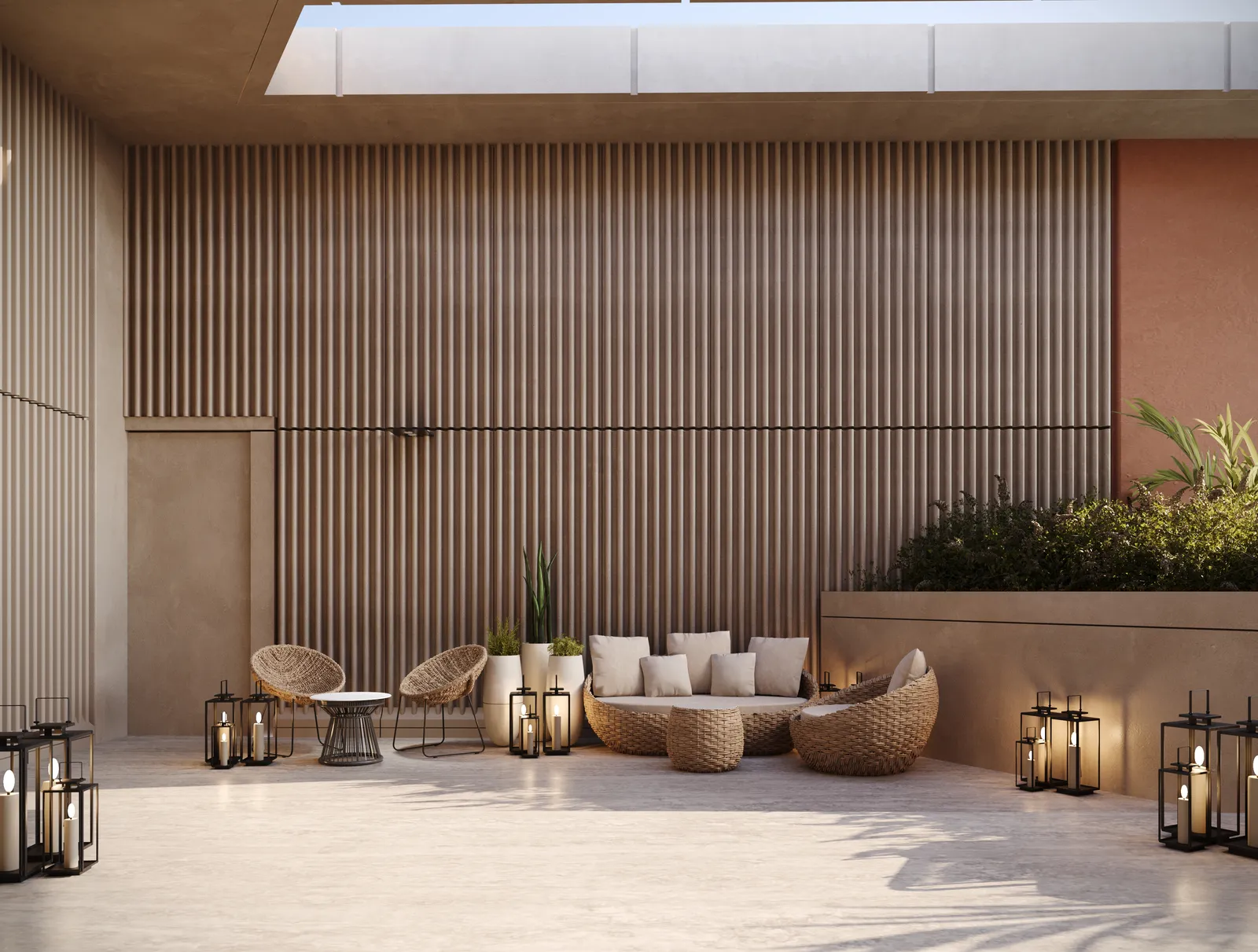 The outdoor lounge: rattan chairs and a sofa with lanterns in front of a slatted timber wall and a planted bed