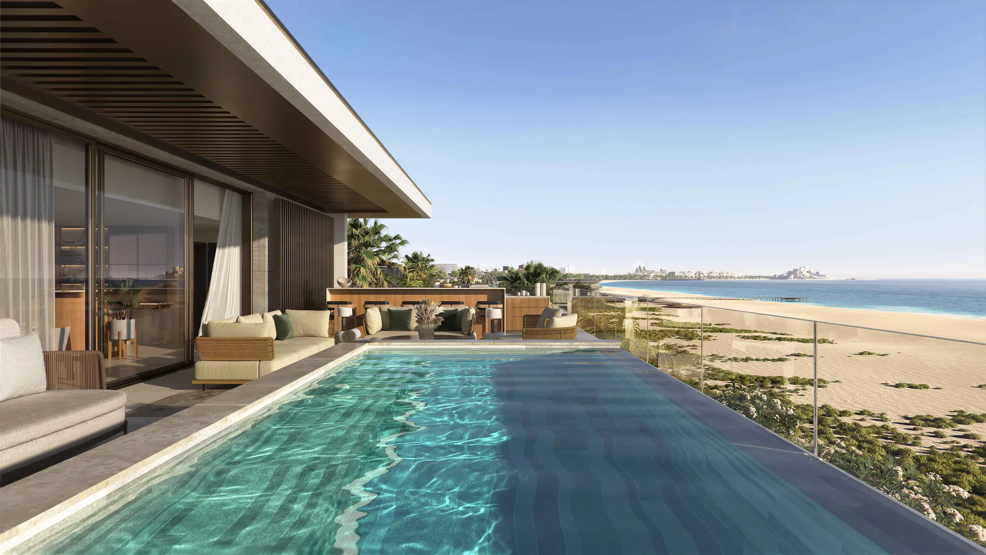 An upper-terrace infinity pool running towards the beach, the coast and the sea beyond