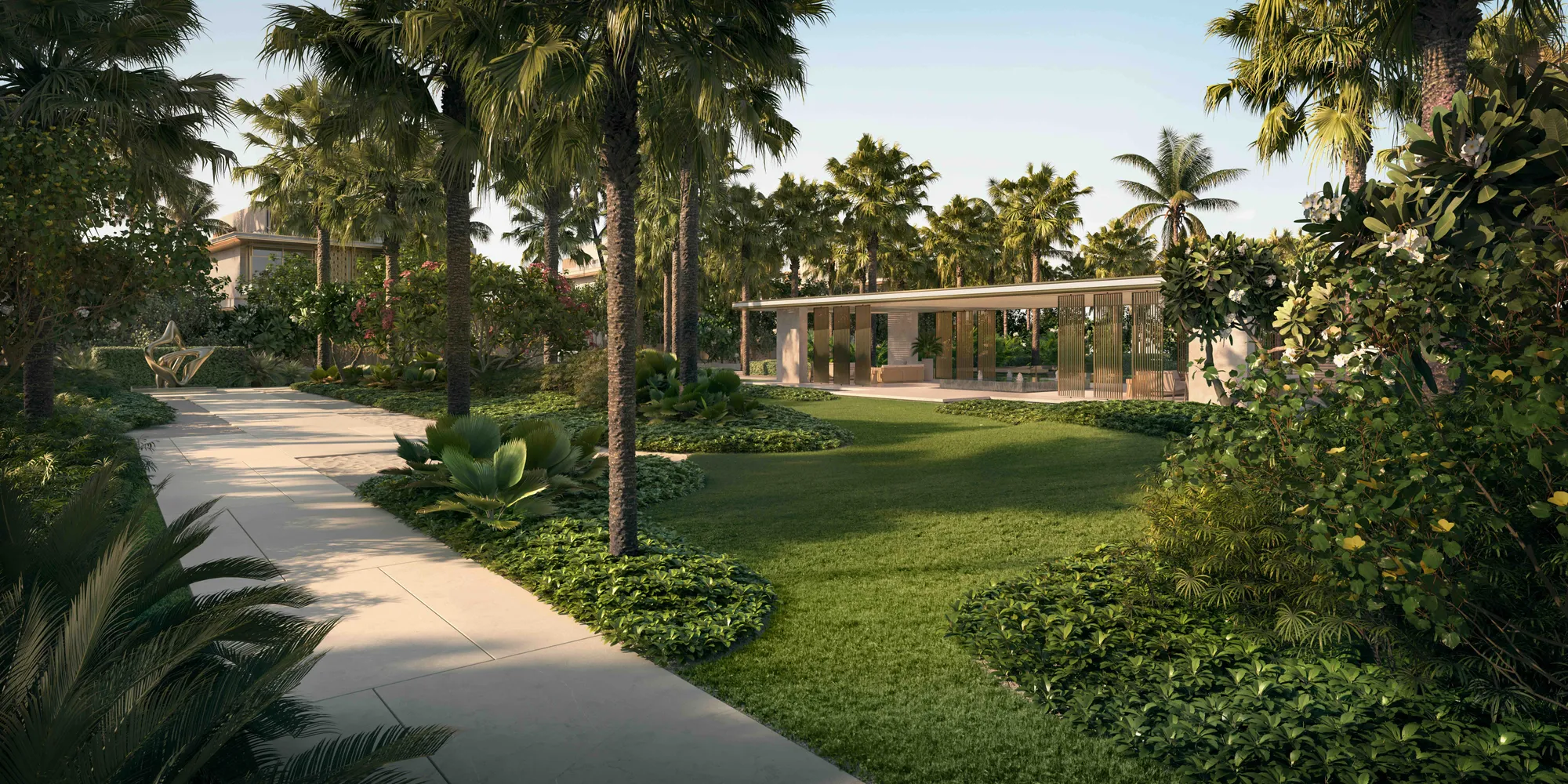 A garden path to a pavilion among palms and lawns