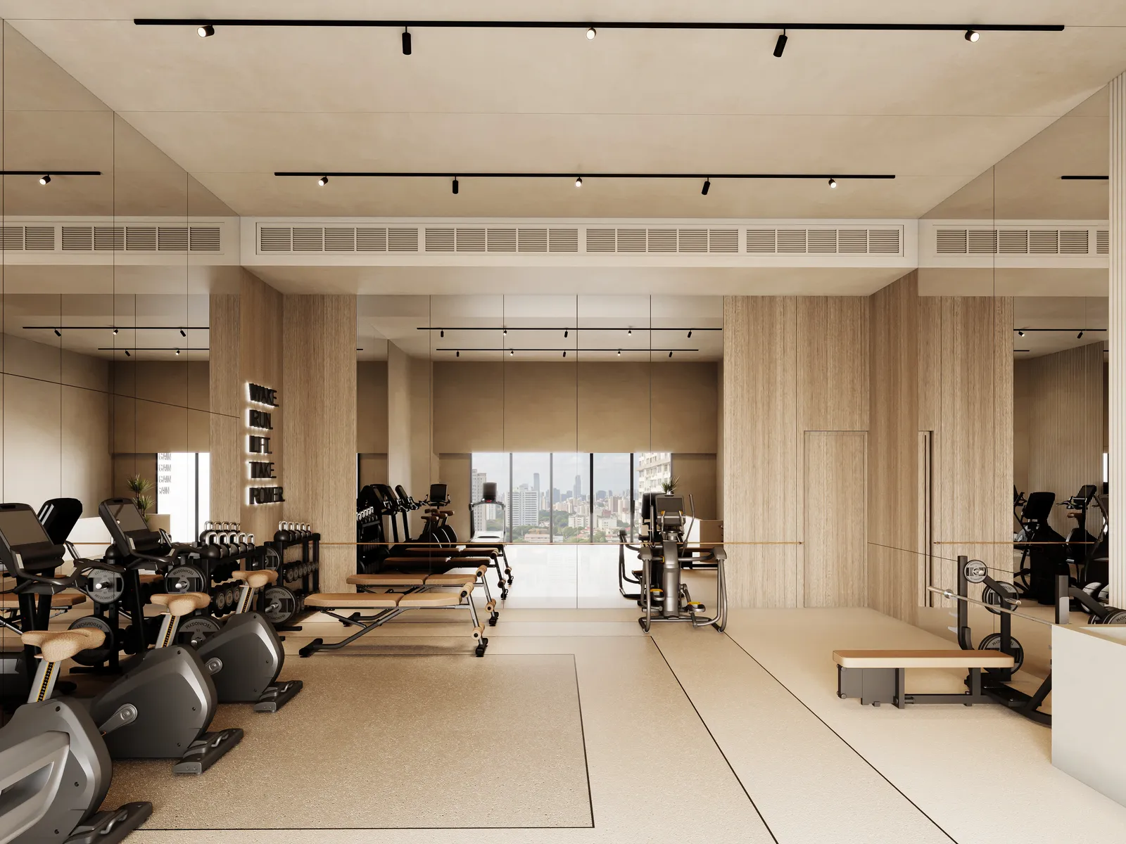 The gym looking down its length: cross-trainers, bikes and benches between mirrored walls, a glazed wall at the far end